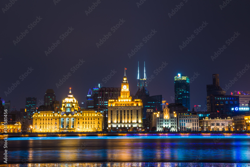 Night view of River Boats on the Huangpu River and as Background the Skyline of the Northern Part of Puxi 