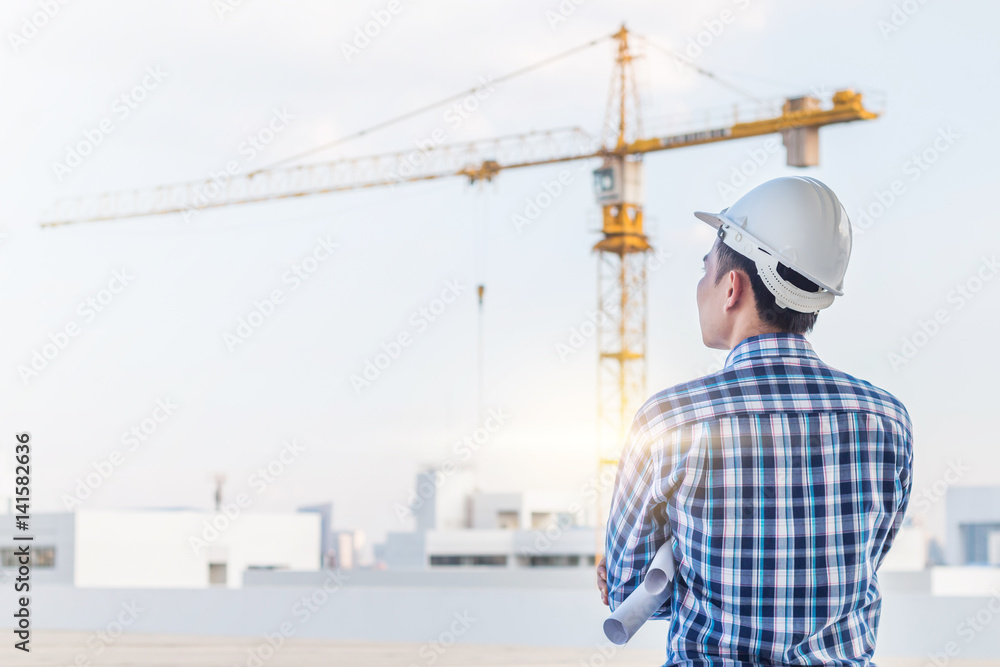 Portrait of engineer wear white helmet safety on construction site with crane background