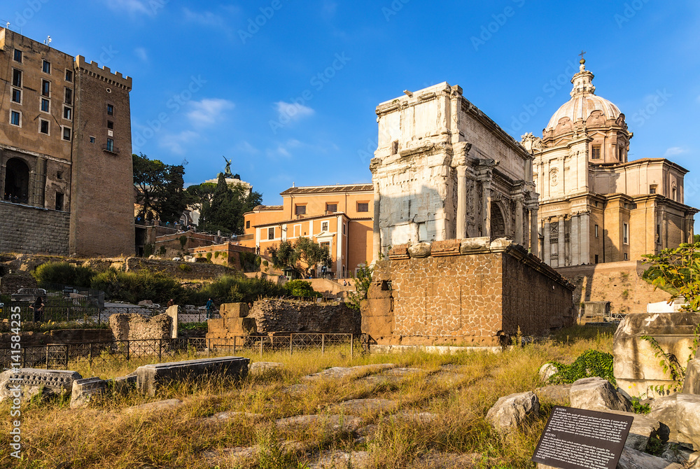 Rome, Italy. The ruins of Rostra and the triumphal arch of the emperor Septimius Severus at the Rome forum, 205.