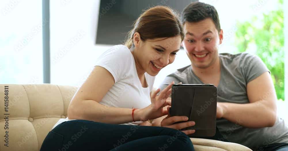 Young Couple using interent on digital tablet Young Couple using interent on digital tablet