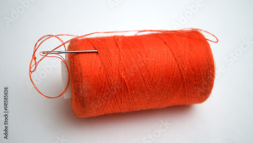 The orange thread with a needle