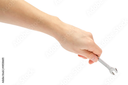hand of young girl holding wrench.