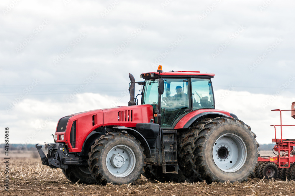 Farmer tractor working in the field. Spring time for sowing. Planting crops. Farmer tractor working in the field. Spring time for sowing. Planting crops.