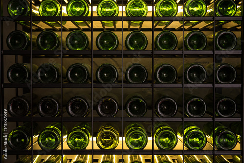 Wall of back-lit green bottles. Backround picture photo