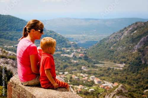 mother with kids trave in mountains