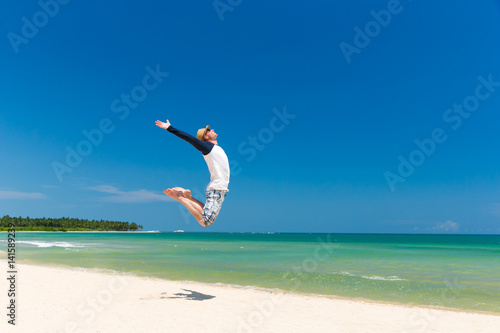 man jump on beach