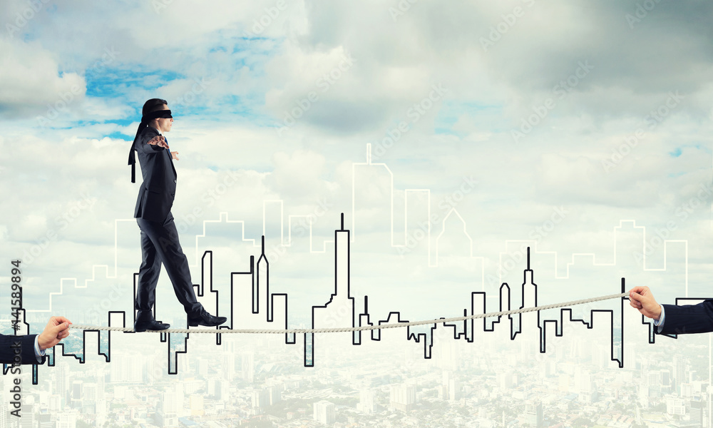 Business concept of risk support and assistance with man balancing on rope Business concept of risk support and assistance with man balancing on rope
