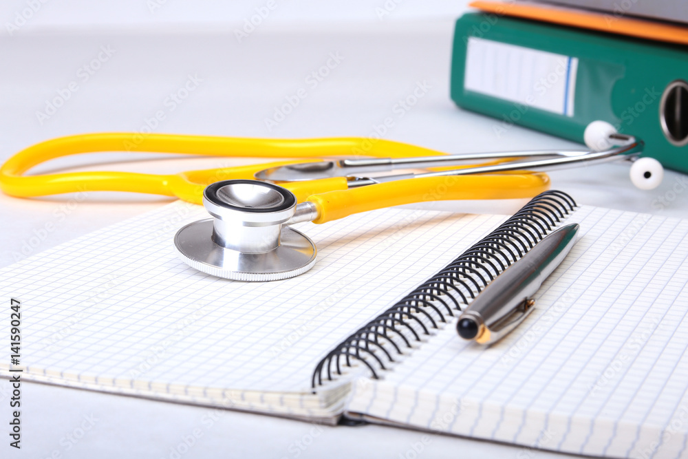 Folder file, stethoscope and note on the desk. blurred background. Folder file, stethoscope and note on the desk. blurred background.