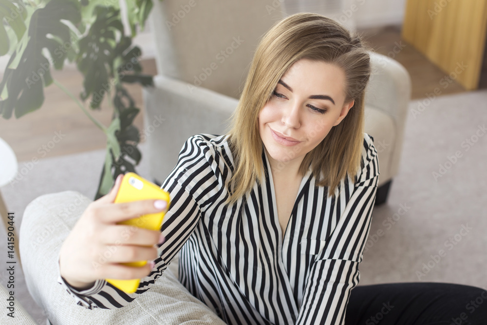 Close up portrait of a beautiful young woman taking a selfie while relaxing on the sofa at home Close up portrait of a beautiful young woman taking a selfie while relaxing on the sofa at home