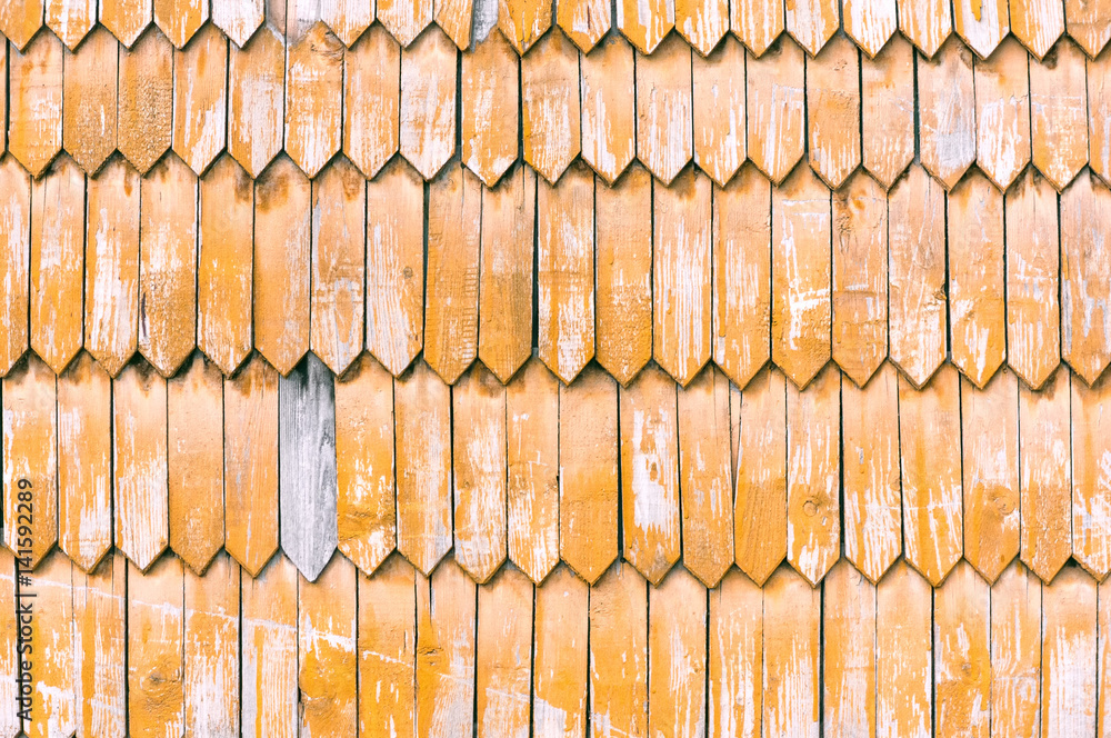 Old wall decorated with yellow retro wooden planks texture background