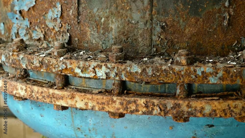 Rusted nuts of the boiler in the abandoned factory. Smooth and slow dolly shot