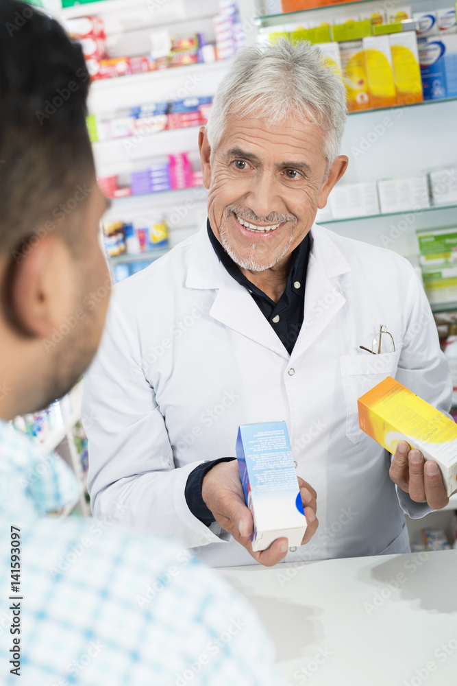 Obraz premium Senior Chemist Holding Products While Looking At Customer