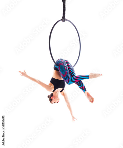Woman hanging in aerial ring, isolated on white