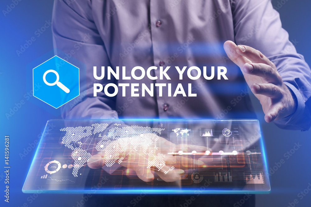 Fototapeta premium Business, Technology, Internet and network concept. Young businessman working on a virtual screen of the future and sees the inscription: Unlock your potential