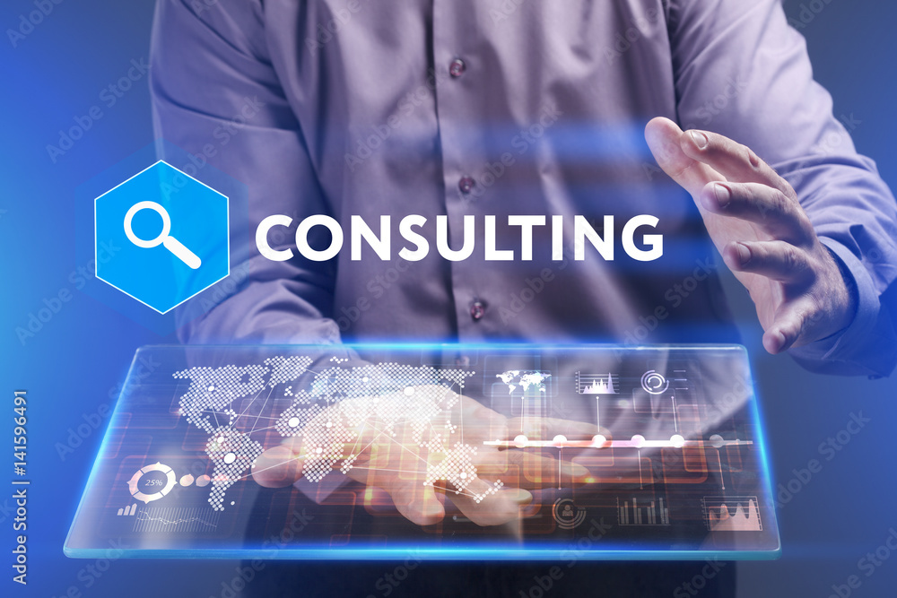 Fototapeta premium Business, Technology, Internet and network concept. Young businessman working on a virtual screen of the future and sees the inscription: Consulting