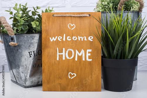 Wooden board with text welcome home photo