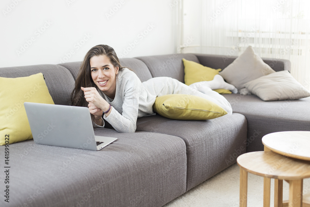Young woman working on laptop at home. Morning scene Young woman working on laptop at home. Morning scene