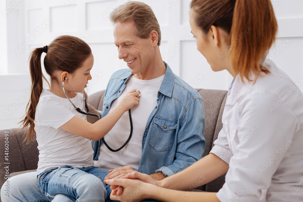 Future little doctor consulting her dad Future little doctor consulting her dad
