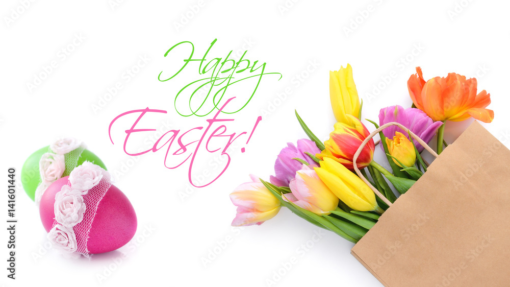 Fresh colorful tulip flowers in paper bag on white background