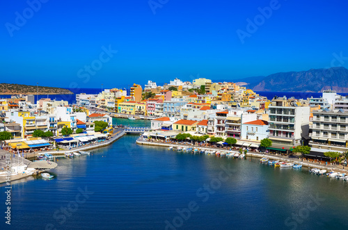 Fototapeta Naklejka Na Ścianę i Meble -  The lake Voulismeni in Agios Nikolaos,  a picturesque coastal town with colorful buildings around the port in the eastern part of the island Crete, Greece