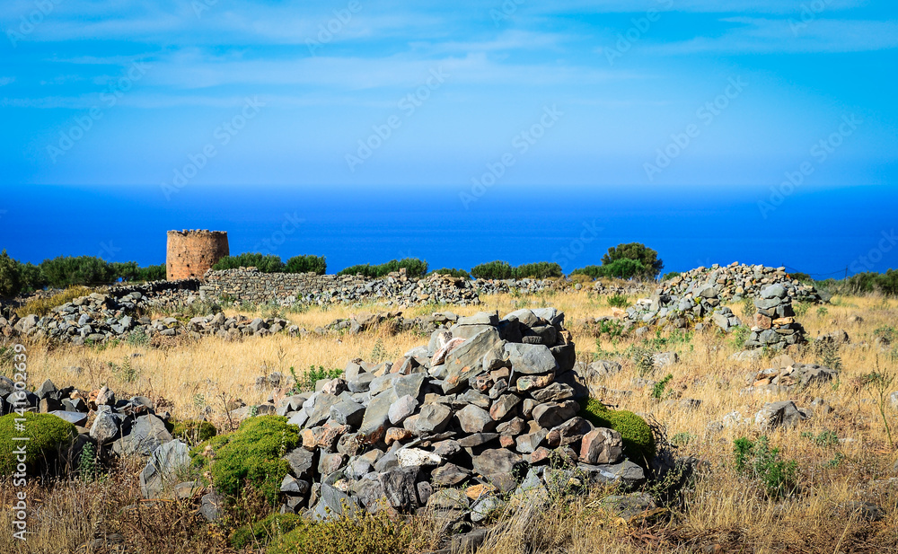 Typical cretan landscape with ruins of old windmills and stone fence, Eastern Crete, Greece