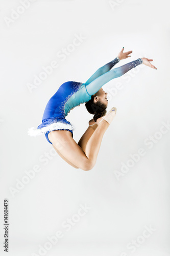 Beautiful gymnast athlete doing exercise. Isolated on white.