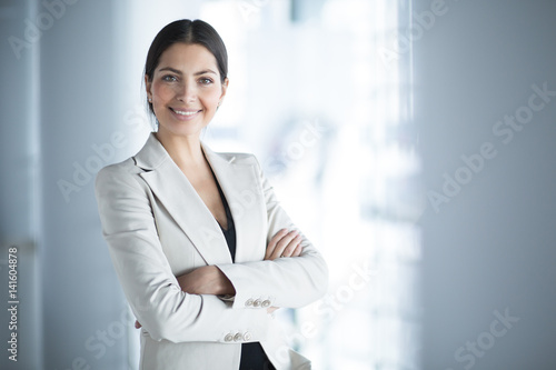 Bild auf Leinwand Smiling Female Business Leader With Arms Crossed
