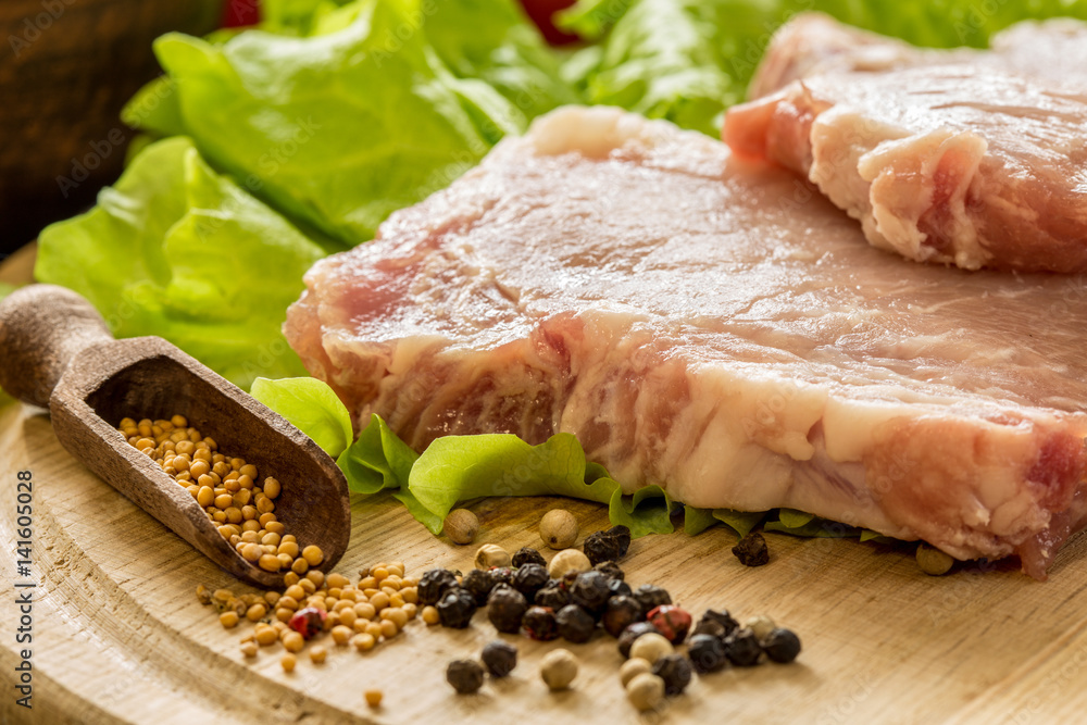 Slices of raw meat. Pork escalope on a wooden board. Slices of raw meat. Pork escalope on a wooden board.