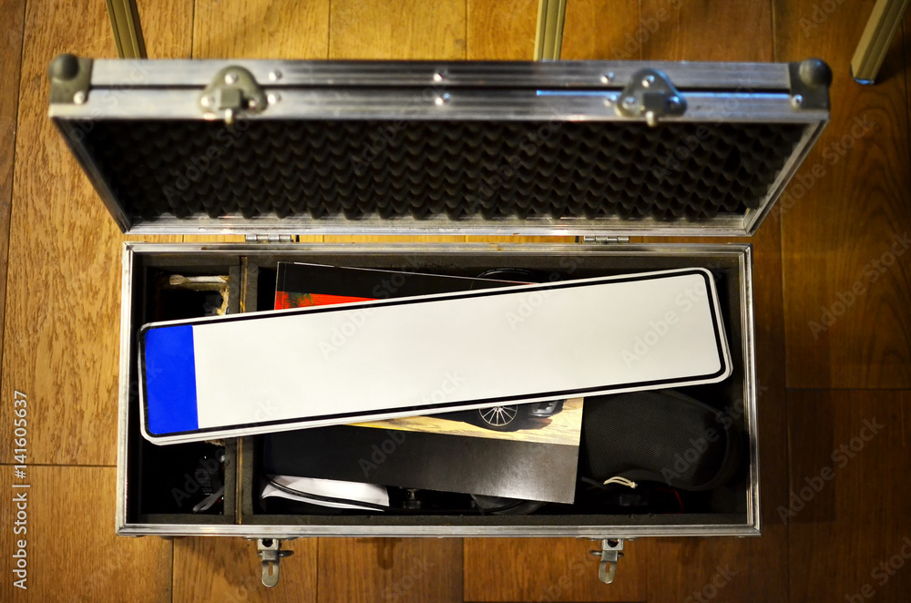 Empty license plate in suitcase on the floor, mockup Empty license plate in suitcase on the floor, mockup