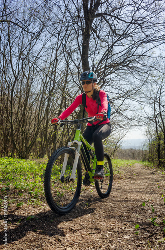 Woman cycling in the forest