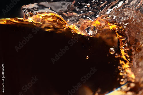 splashing of alcoholic drink on a black background