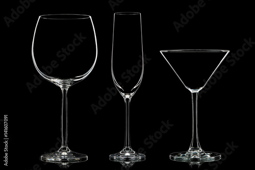 Silhouette of different glasses on black background