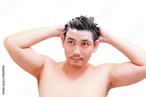 young man taking a shower and standing under flowing water in bathroom ,isolated on white background