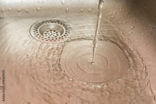 Stainless steel drain of kitchen sink photo