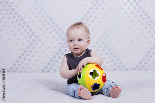 Handsome little boy with a tou ball looking like a coach