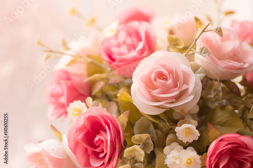 Beautiful Decoration artificial rose flower in pink tone background.
