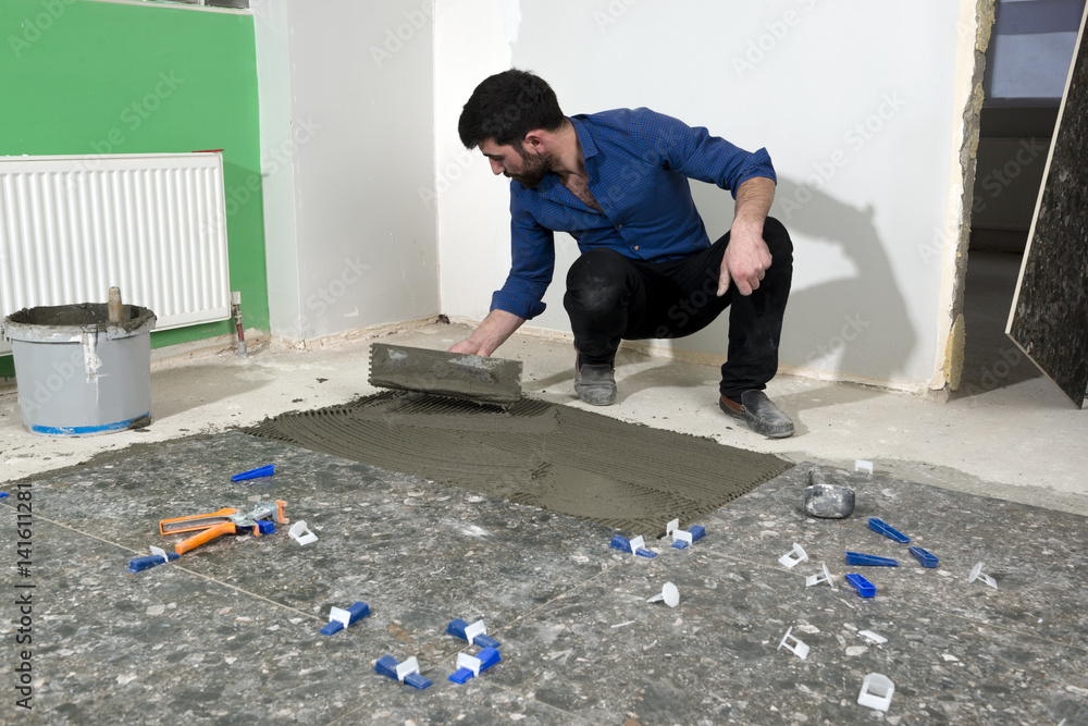 Construction Worker Applying Ceramic Glue