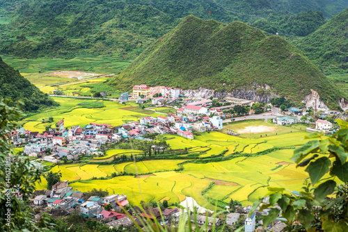 View of small village Fairy bosom in Tam Son town, Quan Ba District, Ha Giang Province, Vietnam.  colorful mixture of paddy fields and house roofs.Twin mountain,double mountain