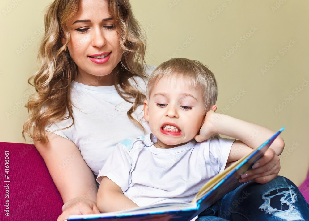 happy baby boy learning to read, Mama reads fairy tales to his son happy baby boy learning to read, Mama reads fairy tales to his son