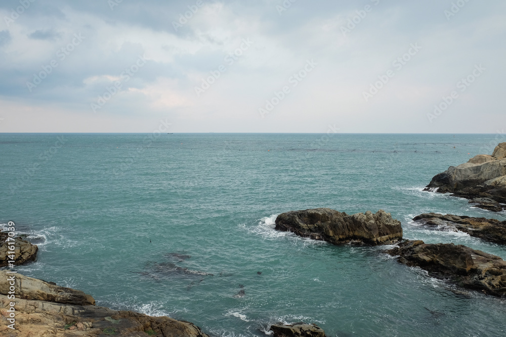 Sea view and rock reef with cloudy sky in Busan, South Korea