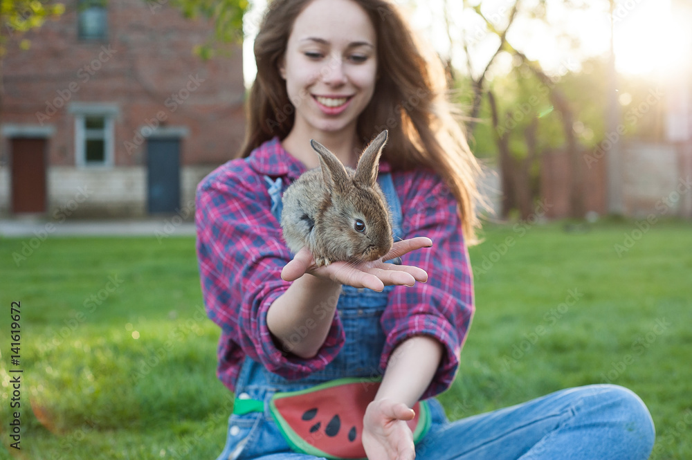 Girl with a rabbit outside. Spring concept Girl with a rabbit outside. Spring concept
