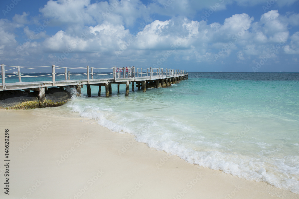 Long pier on the beach of the Caribbean sea.