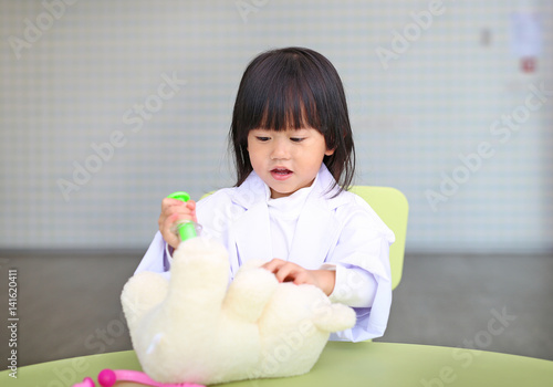 Cute little girl plays doctor