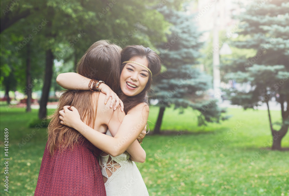 Two happy young girls hug each other in summer park Two happy young girls hug each other in summer park