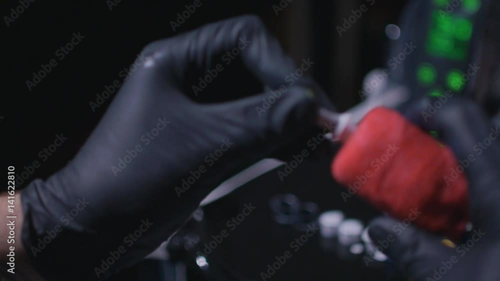 Preparation for tattooing a client in a tattoo parlor. tattooist remove the toner cartridge Preparation for tattooing a client in a tattoo parlor. tattooist remove the toner cartridge