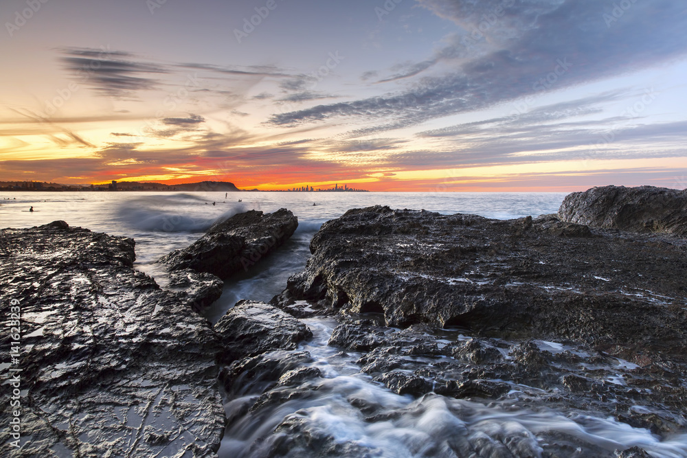 Currumbin Rock Gold Coast sunset with ocean tide coming in on Currumbin Rock