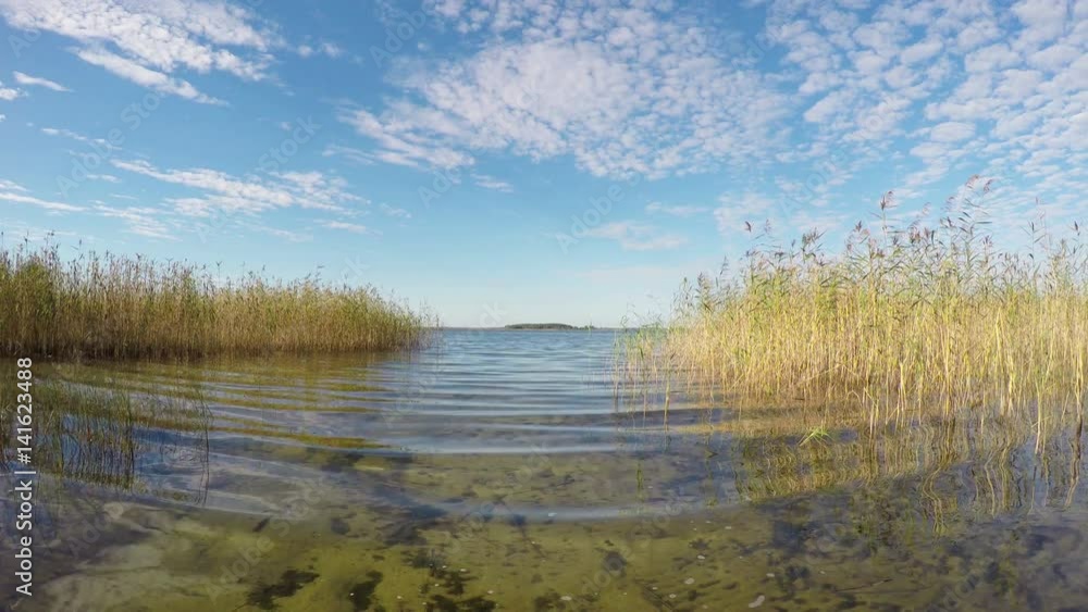 Calm waves on the lake. Braslav lakes in the Belarus. Sunny day Calm waves on the lake. Braslav lakes in the Belarus. Sunny day