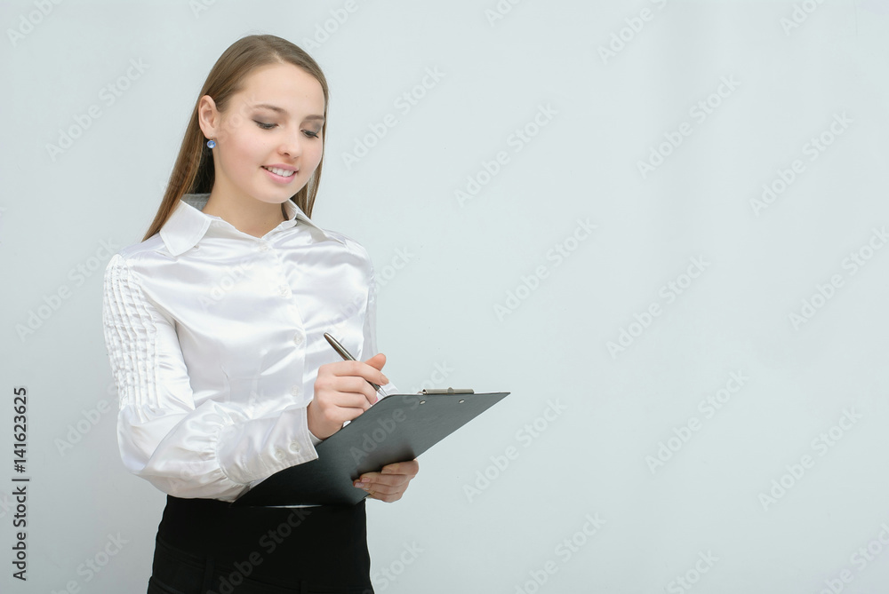 Young pretty business woman with tablet paper isolated on white background Young pretty business woman with tablet paper isolated on white background