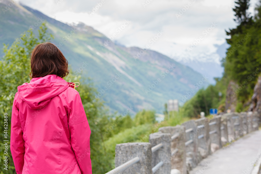 Tourist woman enjoying mountains landscape in Norway.