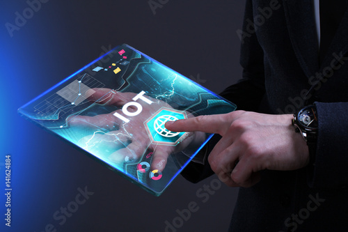 Fototapeta Naklejka Na Ścianę i Meble -  Business, Technology, Internet and network concept. Young businessman working on a virtual screen of the future and sees the inscription: IOT